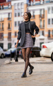 A woman wearing an A-line skirt with a black blazer