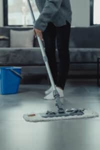 A woman mopping the floor