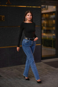 A woman wearing classic jeans and a basic black top