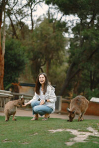 A woman feeding a Wallaby