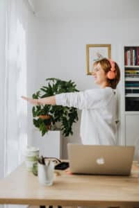 A woman exercising in her home office.