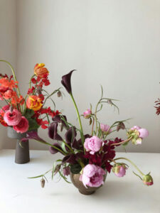 Two beautifully arranged flowers displayed on a table