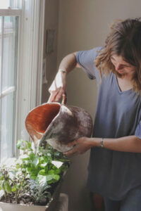 Woman watering her herb garden