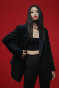 A woman wearing black leggings with blazer