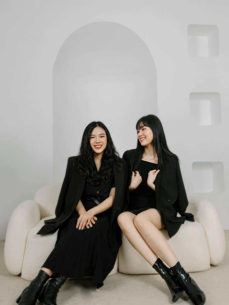 Two women sitting on a couch.