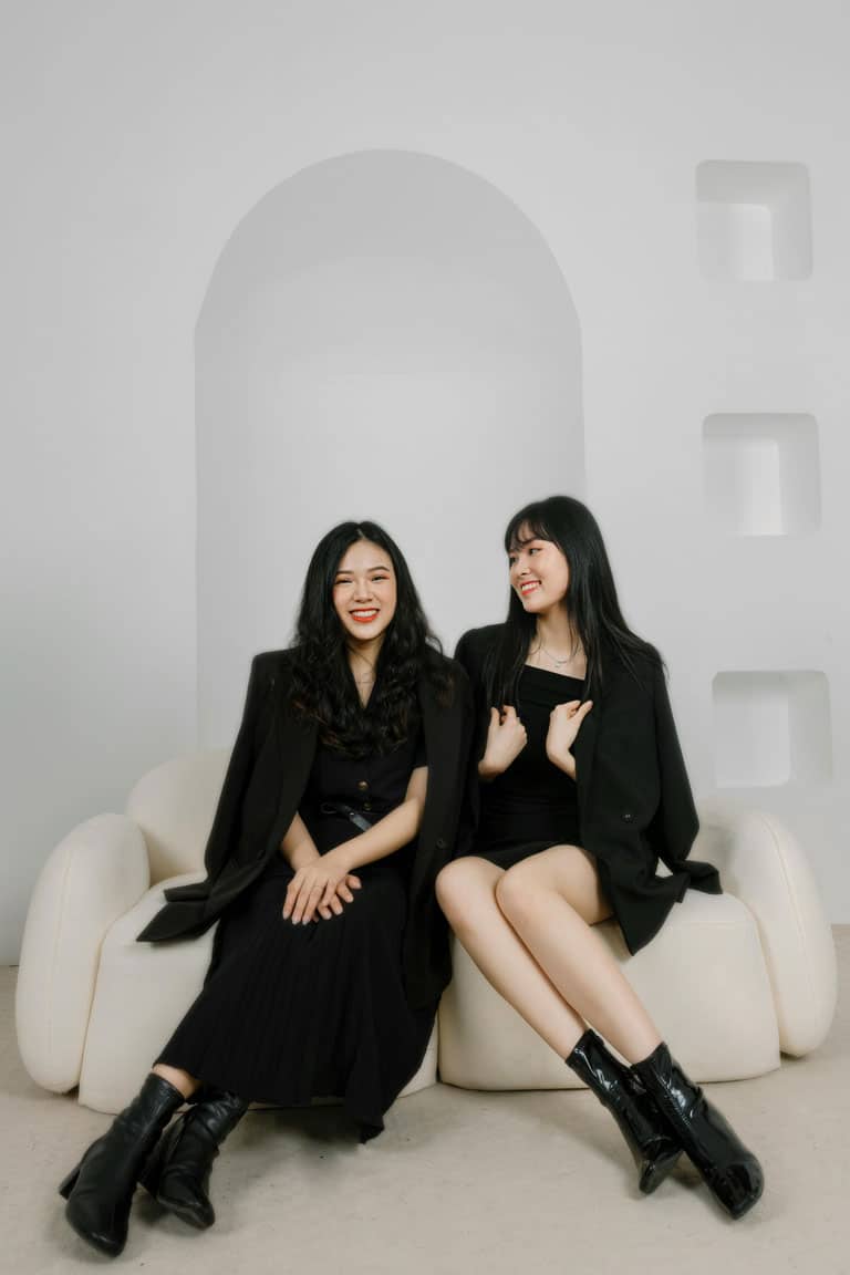 Two women sitting on a couch.