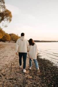 A couple walking along the shoreline