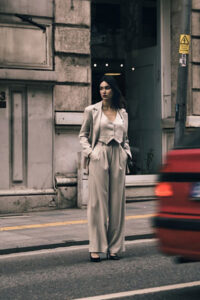 A woman wearing a light grey suit