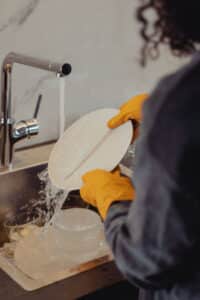 A woman cleaning her dishes.