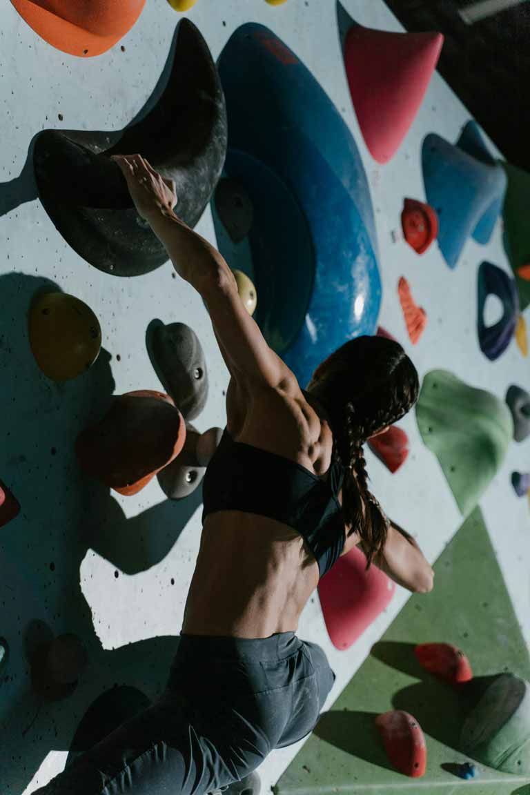 A woman doing indoor rock climbing