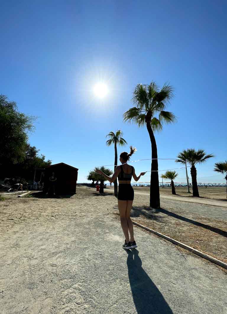 A woman skipping at the beach